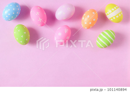 Happy Easter holiday greeting card concept. Colorful Easter Eggs and spring flowers on pastel pink background. Flat lay, top view, copy space. Happy Easter holiday greeting card concept. Colorful Easter Eggs and spring flowers on pastel pink background. Flat lay, top view, copy space. 101140894