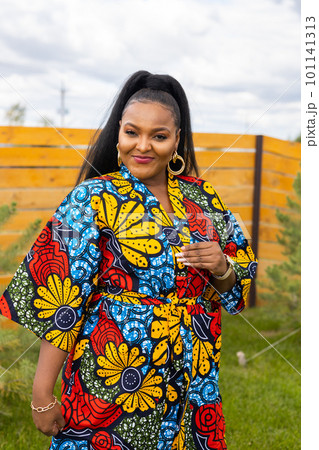 Portrait of beautiful african american woman having fun on village or suburbian. Outdoor portrait of a smiling african girl. Happy cheerful female laughing in countryside summer time and inclusion Portrait of beautiful african american woman having fun on village or suburbian. Outdoor portrait of a smiling african girl. Happy cheerful female laughing in countryside summer time and inclusion 101141313