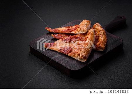 Delicious fresh pepperoni pizza with sesame seeds on the sides 101141838