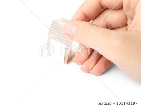 Woman putting sticking plaster on white background. First aid item Woman putting sticking plaster on white background. First aid item 101143197
