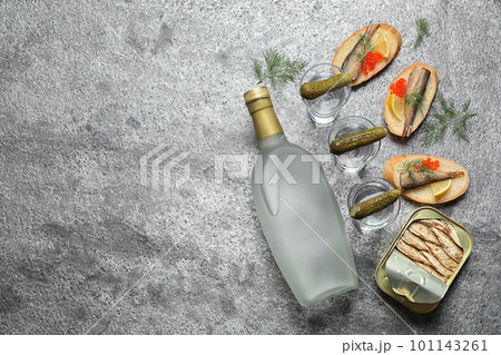 Flat lay composition with cold Russian vodka on grey table. Space for text Flat lay composition with cold Russian vodka on grey table. Space for text 101143261