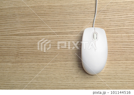 Wired computer mouse on wooden background, top view. Space for text 101144516