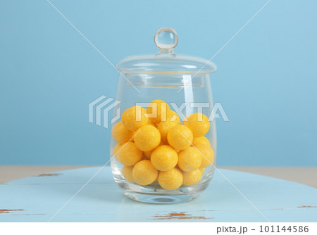 Tasty lemon drops in glass jar on wooden table Tasty lemon drops in glass jar on wooden table 101144586