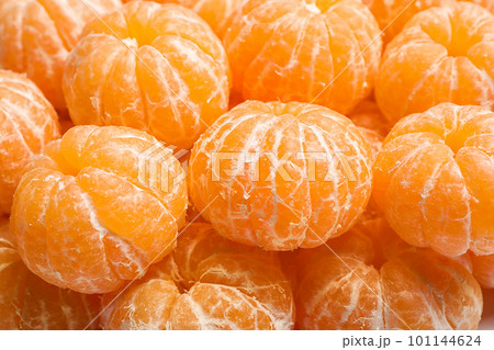 Peeled fresh ripe tangerines as background, closeup 101144624