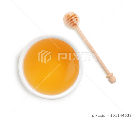 Bowl of organic honey and dipper isolated on white, top view 101144638