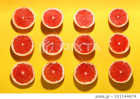 Flat lay composition with tasty ripe grapefruit slices on yellow background 101144674