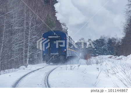 Retro steam train moves at winter morning time. Retro steam train moves at winter morning time. 101144867