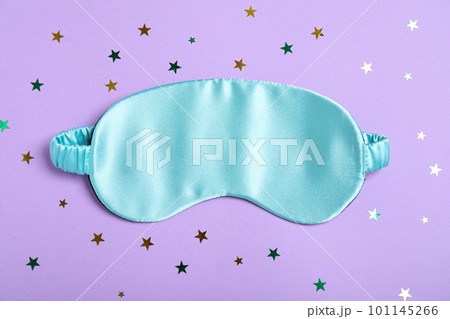 Sleeping mask and glitter on violet background, flat lay. Bedtime accessory 101145266