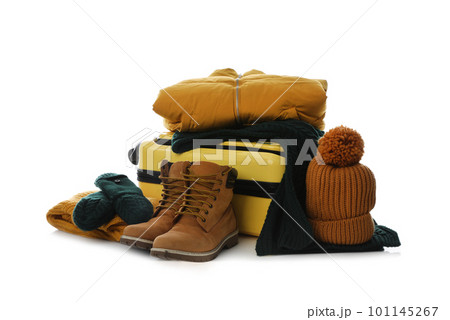 Suitcase with warm clothes isolated on white. Winter vacation Suitcase with warm clothes isolated on white. Winter vacation 101145267
