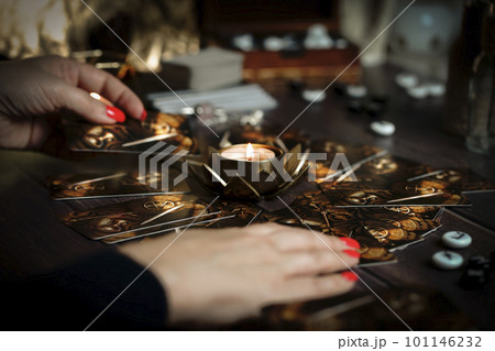 Blurred tarot cards on the table, esoteric concept, fortune telling predictions 101146232