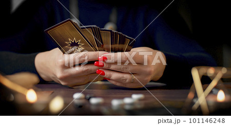 Blurred tarot cards on the table, esoteric concept, fortune telling predictions Blurred tarot cards on the table, esoteric concept, fortune telling predictions 101146248