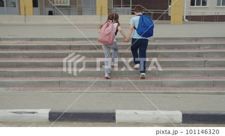 child students cross road zebra crossing. friends classmates pass car pedestrian crossing sign. give way child sign. boy girl with school backpacks run school by hand. brother sister child with city 101146320