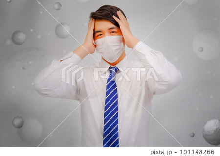 Asian man wear masks to protect PM 2.5 dust and air pollution and headache and sickness, air pollution concept, healthcare concept. 101148266
