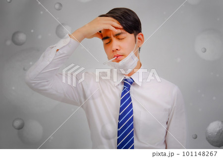 Asian man wear masks to protect PM 2.5 dust and air pollution and headache and sickness, air pollution concept, healthcare concept. 101148267