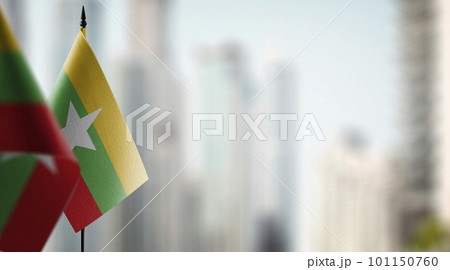 Small flags of the Myanmar on an abstract blurry background 101150760