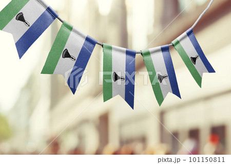 A garland of Lesotho national flags on an abstract blurred background A garland of Lesotho national flags on an abstract blurred background 101150811