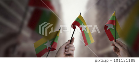 A group of people holding small flags of the Myanmar in their hands 101151189