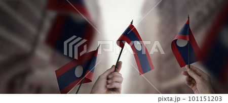 A group of people holding small flags of the Laos in their hands 101151203