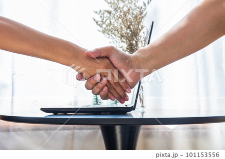 man and woman shaking hands to agree on business man and woman shaking hands to agree on business 101153556