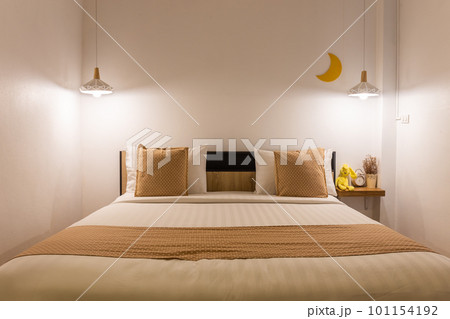 white cute bedroom interior with lamp and wooden in night time. 101154192