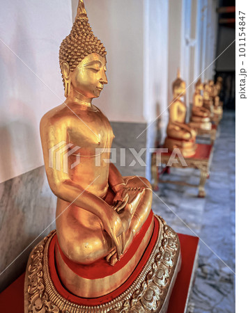 Gallery with old vessels of the seated Buddha in the Buddhist temple Wat Arun. Bangkok, Thailand Gallery with old vessels of the seated Buddha in the Buddhist temple Wat Arun. Bangkok, Thailand 101154847