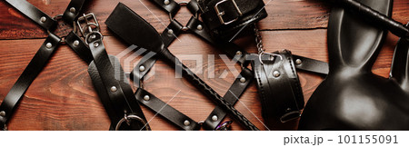 set of sex toys for hard BDSM sex with domination and submission. Leather whip, handcuffs, belt 101155091