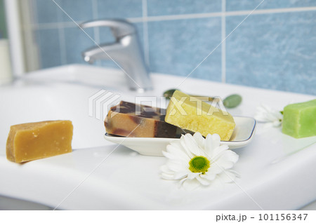 Craft organic soap bars on washbasin in the home bathroom. Purity. Hygiene. Home spa. Skin and body care concept. 101156347