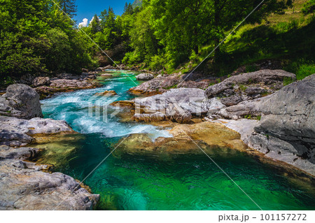 Emerald color Soca river with rocky shoreline, Bovec, Slovenia Emerald color Soca river with rocky shoreline, Bovec, Slovenia 101157272