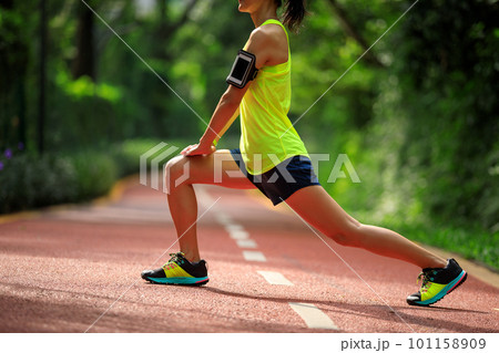 Healthy lifestyle woman runner stretching legs in morning park Healthy lifestyle woman runner stretching legs in morning park 101158909