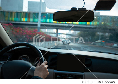 People driving car on city road 101159589