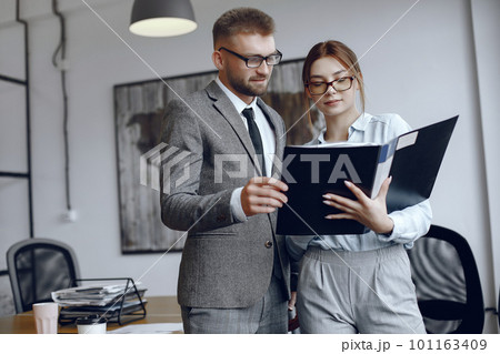 Woman with glasses.Businessman with documents.Colleagues work together 101163409