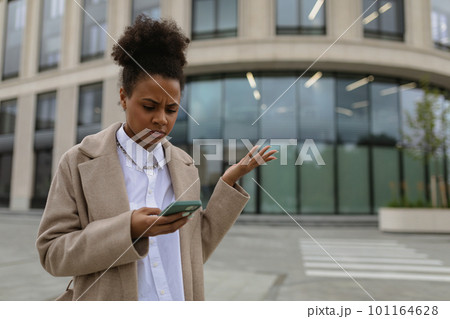 hispanic young woman administrator working remotely using smartphone outdoors 101164628