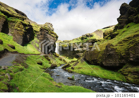 Kvernufoss waterfall flowing through the green valley in sunny day on summer at Iceland 101165401