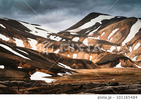 Scenery of majestic volcanic mountain range with snow covered in Fjallabak nature reserve, Icelandic Highlands at Landmannalaugar Scenery of majestic volcanic mountain range with snow covered in Fjallabak nature reserve, Icelandic Highlands at Landmannalaugar 101165484