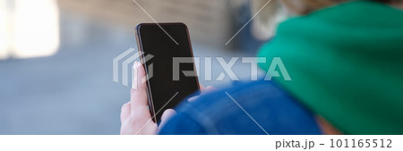Woman on walk in city using smartphone works on street 101165512