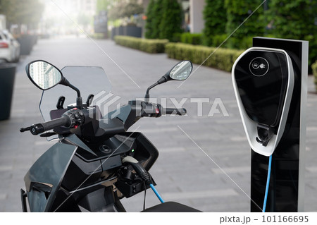 Electric scooter with charging station on a city street 101166695