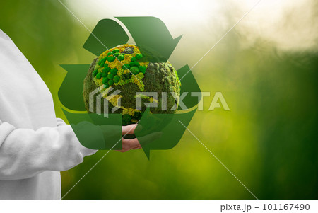 Woman holding a green planet Earth Woman holding a green planet Earth 101167490