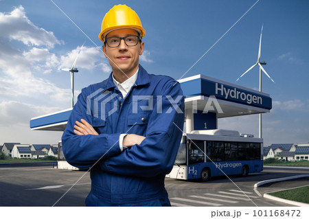 Engineer in a helmet and blue suit on a background of hydrogen filling station 101168472