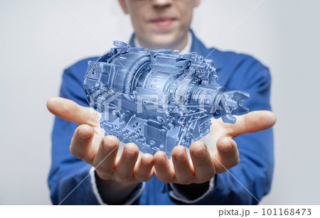 Development engineer holds in his hands a model of an electric transmission Development engineer holds in his hands a model of an electric transmission 101168473
