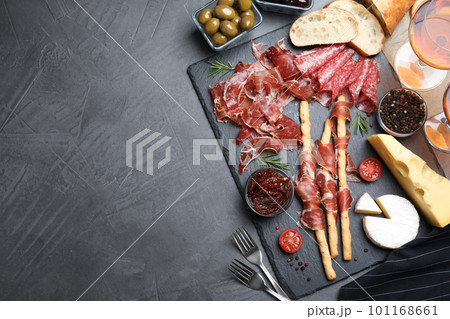 Tasty prosciutto served on grey table, flat lay. Space for text 101168661