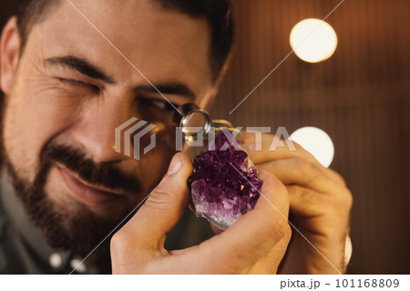 Jeweler working with gemstone on blurred background, closeup 101168809