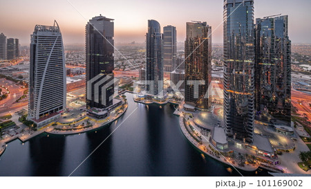 Tall residential buildings at JLT aerial night to day timelapse, part of the Dubai multi commodities centre mixed-use district. Tall residential buildings at JLT aerial night to day timelapse, part of the Dubai multi commodities centre mixed-use district. 101169002