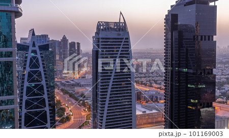 Tall residential buildings at JLT aerial night to day timelapse, part of the Dubai multi commodities centre mixed-use district. Tall residential buildings at JLT aerial night to day timelapse, part of the Dubai multi commodities centre mixed-use district. 101169003
