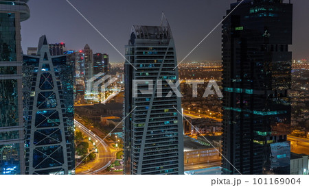 Tall residential buildings at JLT aerial night timelapse, part of the Dubai multi commodities centre mixed-use district. Tall residential buildings at JLT aerial night timelapse, part of the Dubai multi commodities centre mixed-use district. 101169004