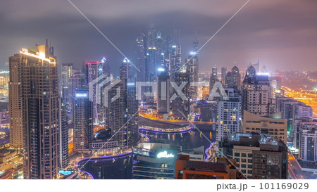 View of various skyscrapers in tallest recidential block in Dubai Marina aerial all night timelapse View of various skyscrapers in tallest recidential block in Dubai Marina aerial all night timelapse 101169029
