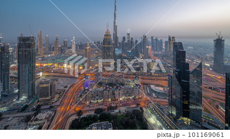 Aerial view of tallest towers in Dubai Downtown skyline and highway day to night timelapse. 101169061