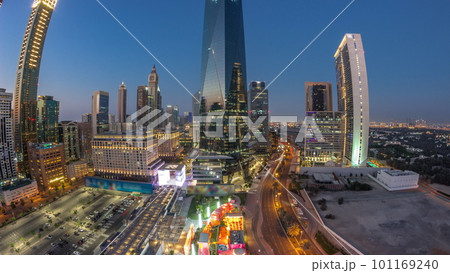 Panorama of Dubai International Financial district aerial day to night timelapse. View of business and financial office towers. Panorama of Dubai International Financial district aerial day to night timelapse. View of business and financial office towers. 101169240