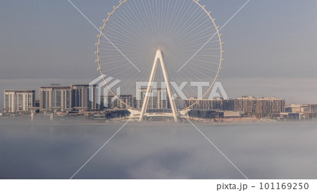 Bluewaters island with modern architecture and ferris wheel covered by morning fog aerial timelapse. 101169250
