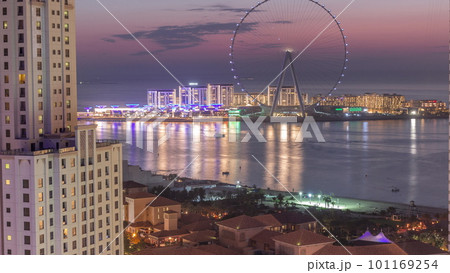 Bluewaters island with modern architecture and ferris wheel aerial day to night timelapse. Bluewaters island with modern architecture and ferris wheel aerial day to night timelapse. 101169254