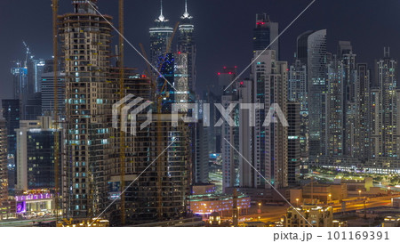 Dubai's business bay towers aerial night timelapse. Rooftop view of some skyscrapers 101169391